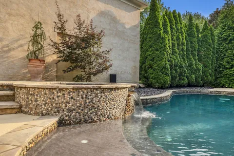 a view of a house with swimming pool and sitting area