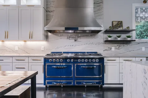 a kitchen with stainless steel appliances a stove and cabinets