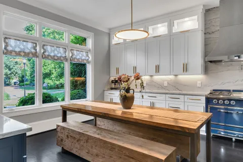 a kitchen with a stove and a large window
