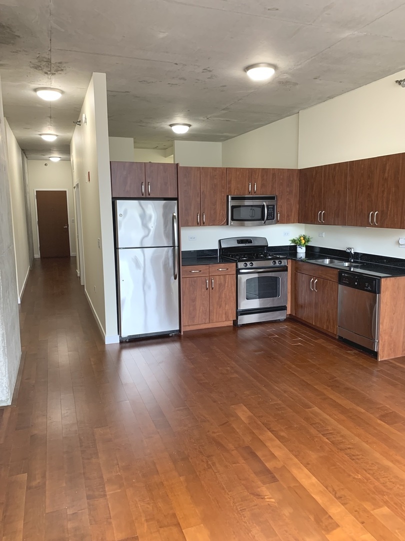 235 West Van Buren Street, Unit 3820 Chicago, IL 60607 - Photo 20 of 38 a kitchen with stainless steel appliances granite countertop a stove a sink and a refrigerator