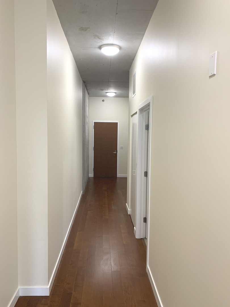 235 West Van Buren Street, Unit 3820 Chicago, IL 60607 - Photo 21 of 38 a view of a hallway with wooden floor