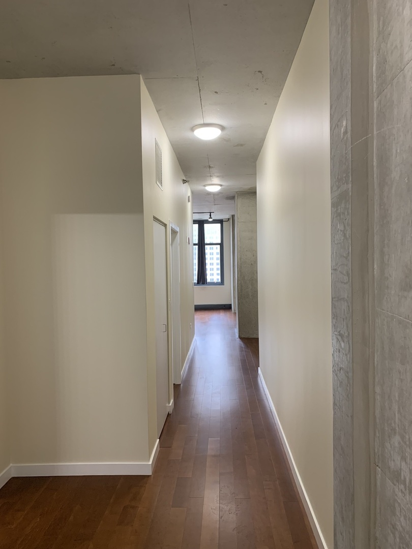 235 West Van Buren Street, Unit 3820 Chicago, IL 60607 - Photo 7 of 38 a view of hallway with wooden floor