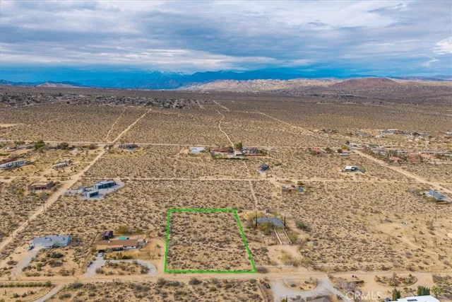 an aerial view of houses covered in trees