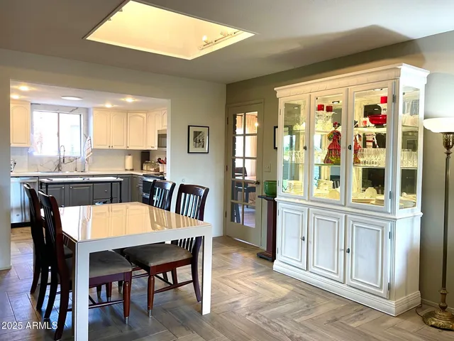 a large dining room with furniture window and wooden floor
