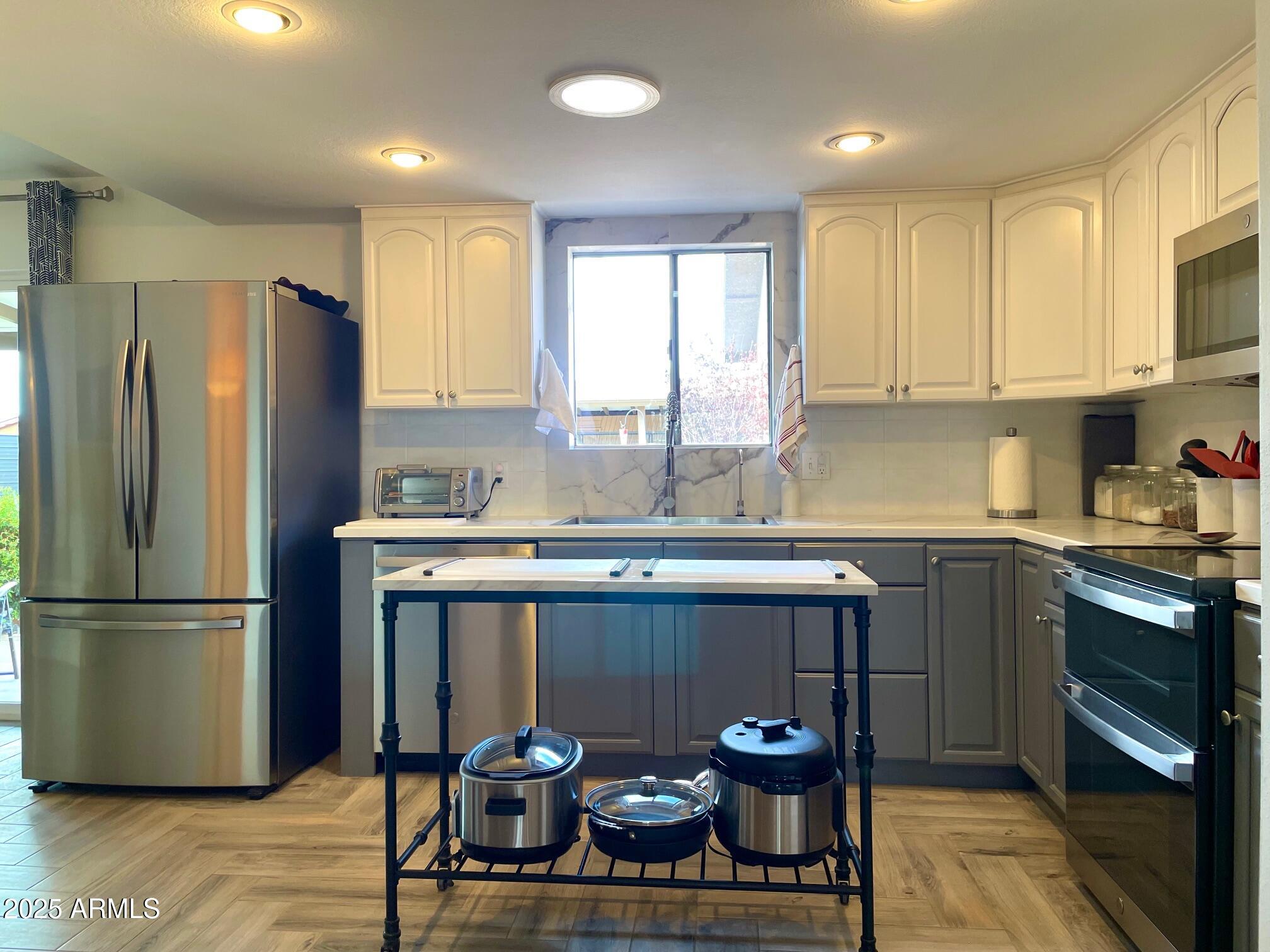 110 Nighthawk Avenue Bisbee, AZ 85603 - Photo 16 of 56 a kitchen with stainless steel appliances granite countertop a refrigerator sink and cabinets