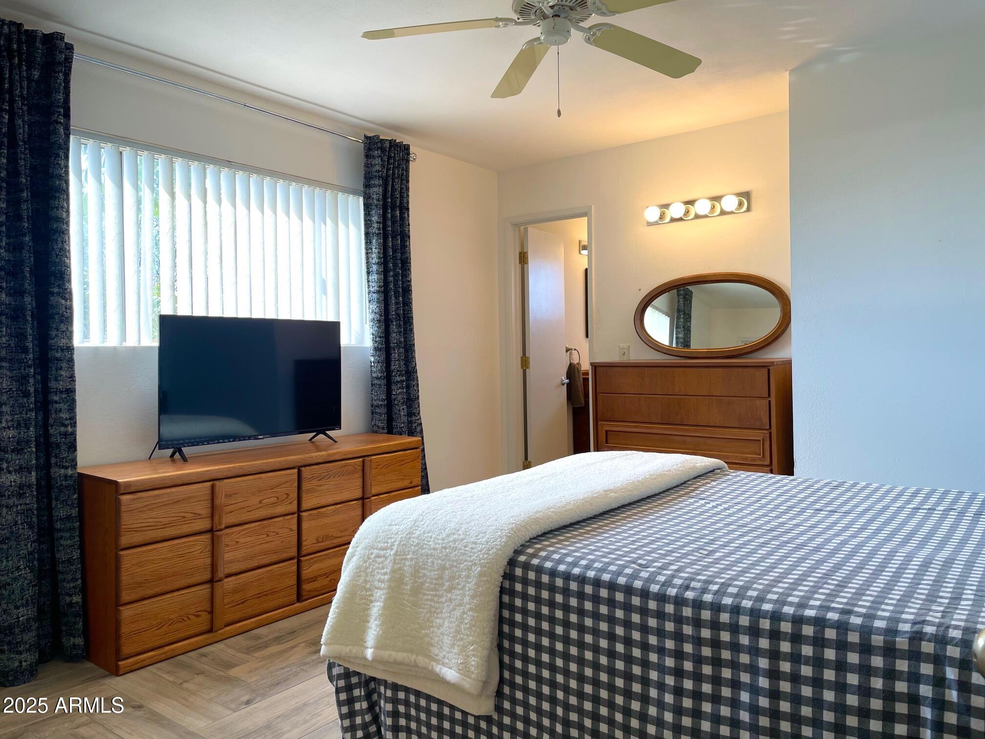 110 Nighthawk Avenue Bisbee, AZ 85603 - Photo 27 of 56 a bedroom with a bed and a flat screen tv