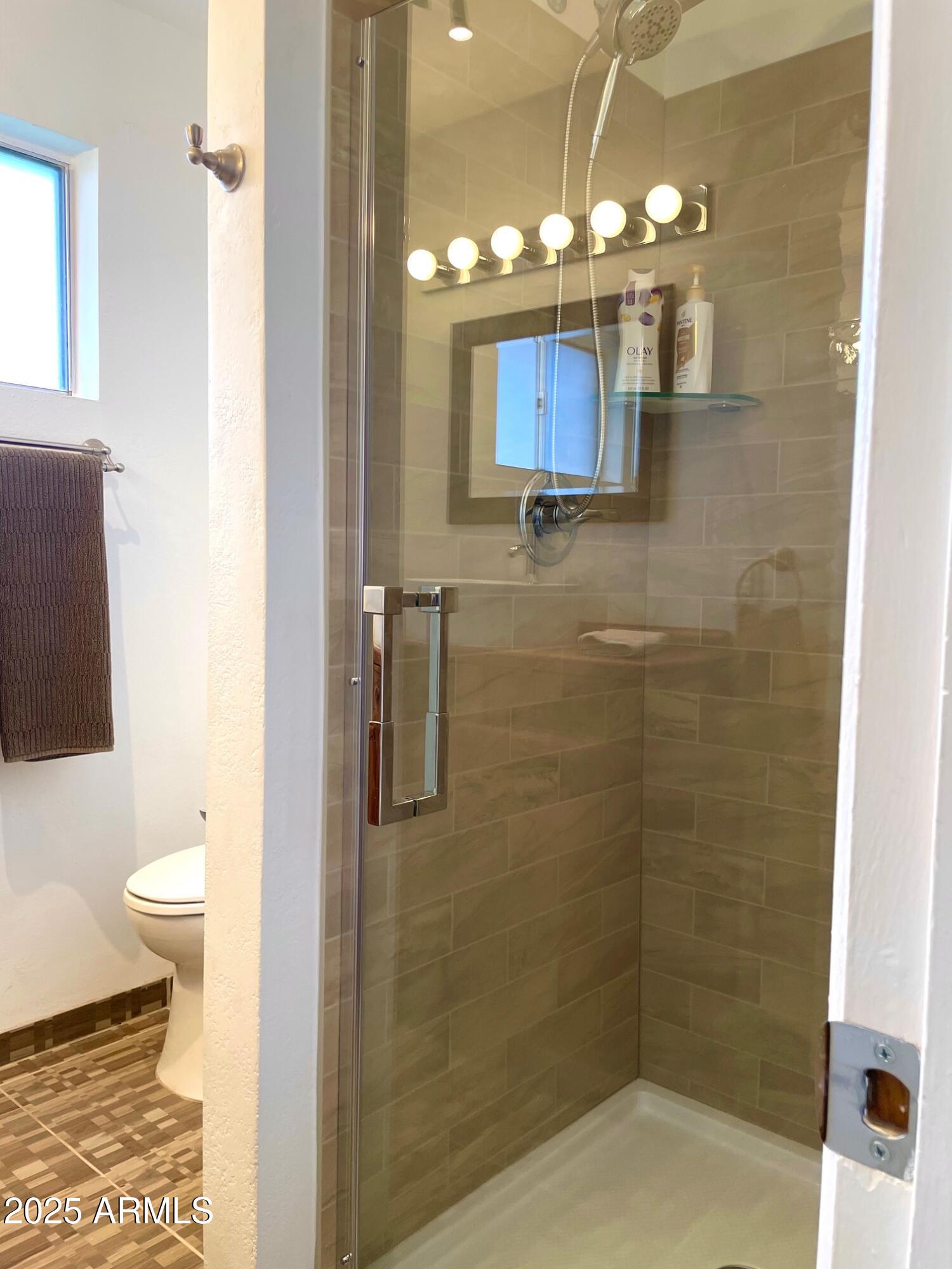 110 Nighthawk Avenue Bisbee, AZ 85603 - Photo 29 of 56 a bathroom with a toilet a sink and shower