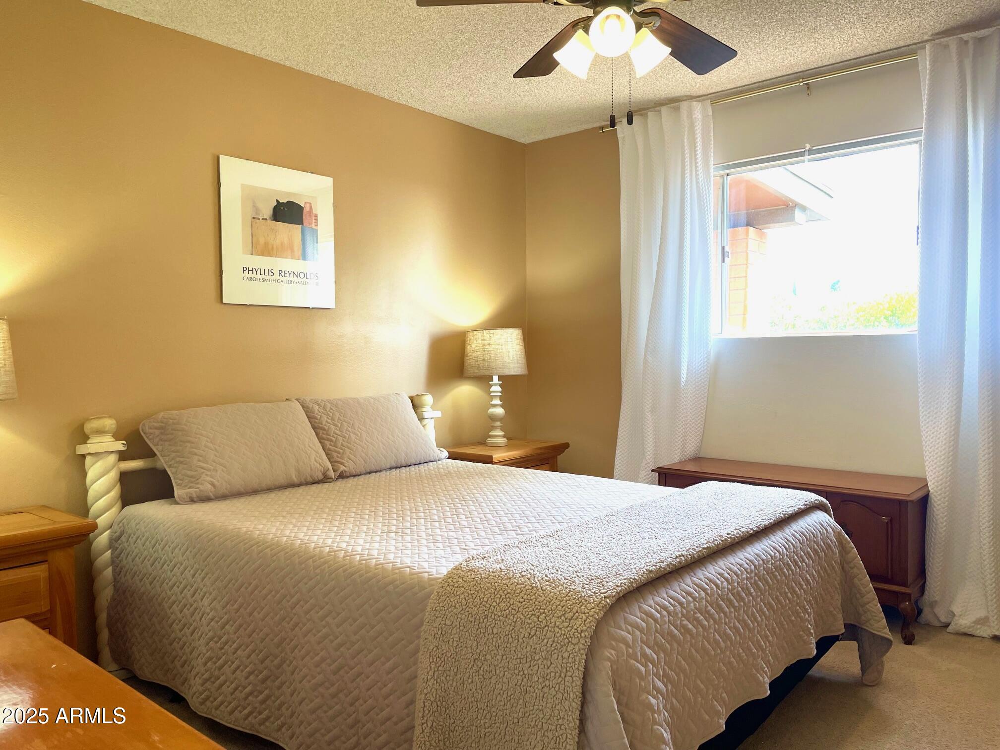 110 Nighthawk Avenue Bisbee, AZ 85603 - Photo 31 of 56 a bedroom with a bed and a chandelier