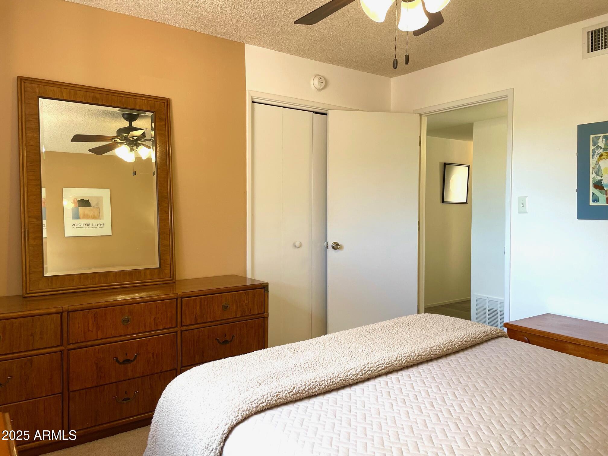 110 Nighthawk Avenue Bisbee, AZ 85603 - Photo 32 of 56 a bedroom with a bed and a mirror on the dresser