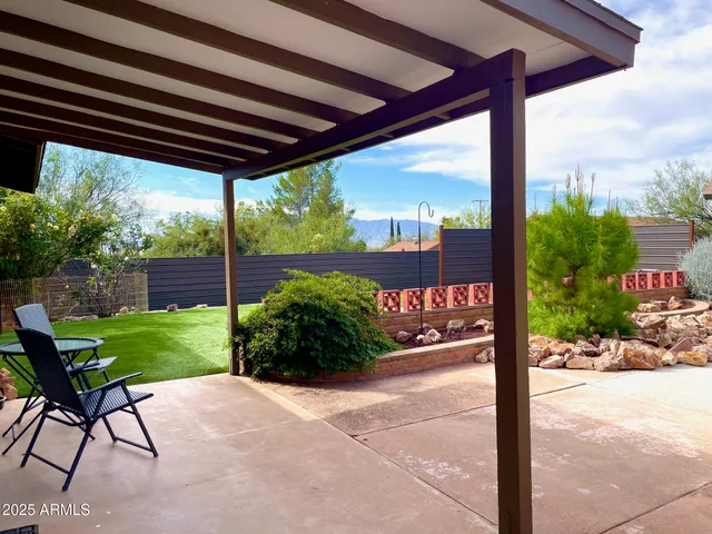 a view of a chairs and table in patio