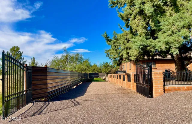 a view of a bench in the roof deck with wooden fence