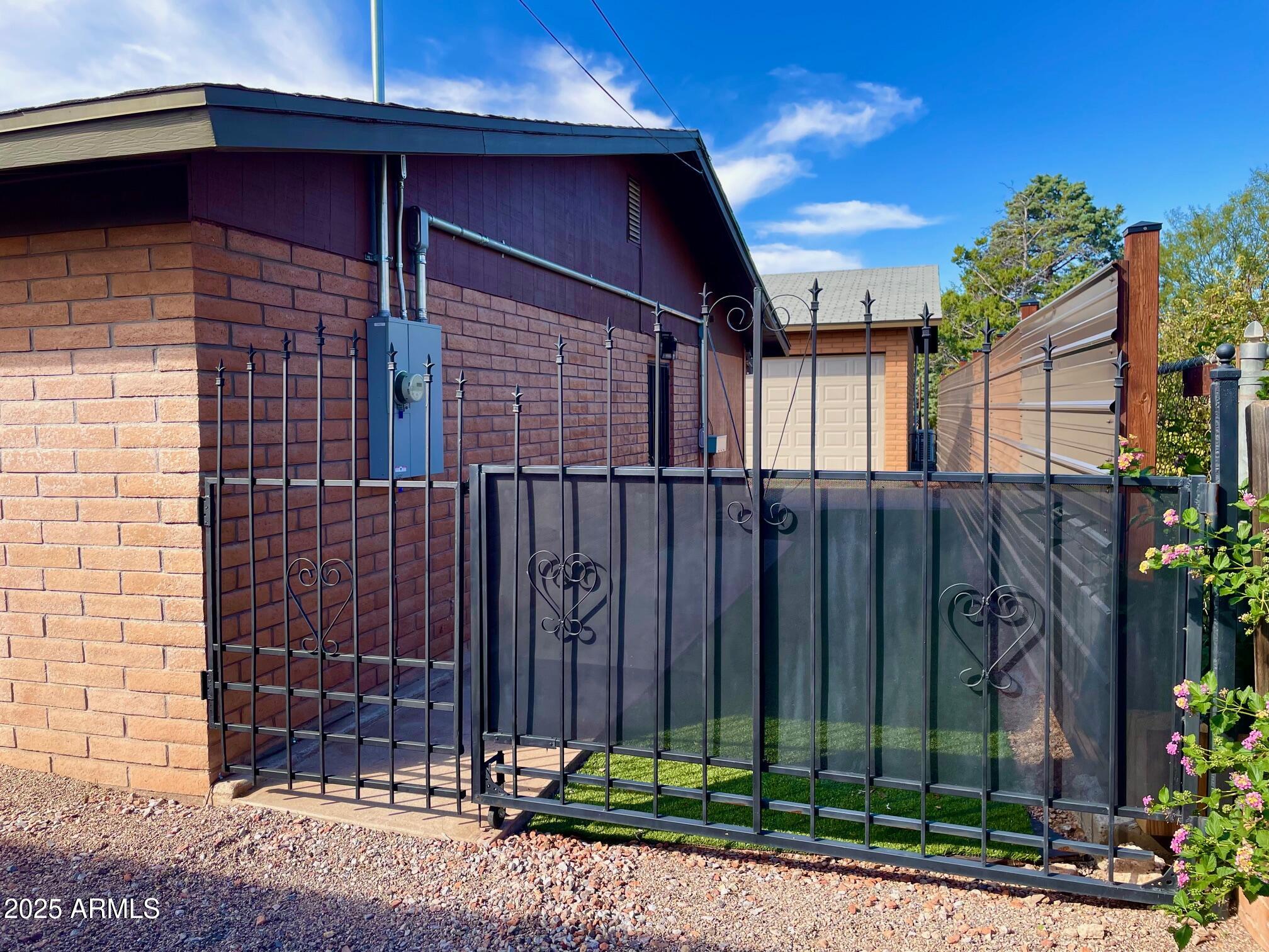 110 Nighthawk Avenue Bisbee, AZ 85603 - Photo 8 of 56 a view of a house with a small yard and wooden fence