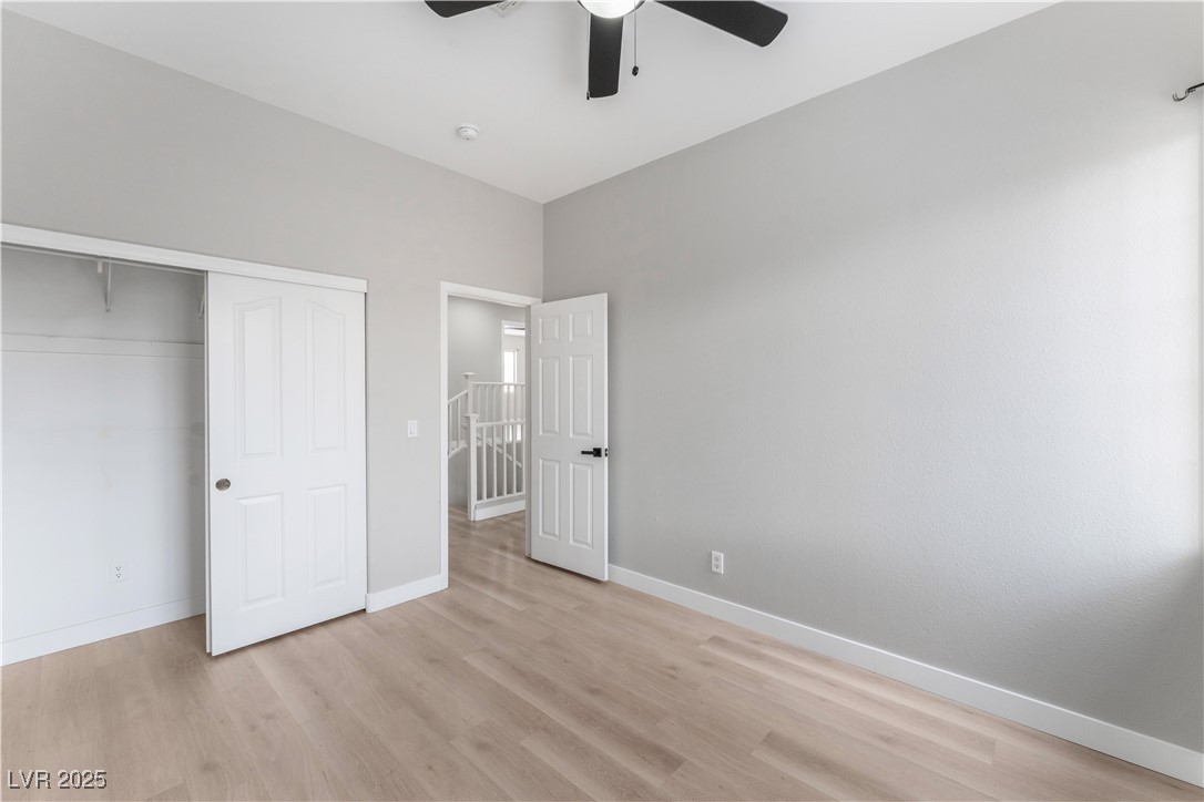 3695 Funston Way Las Vegas, NV 89129 - Photo 34 of 43 Unfurnished bedroom featuring light wood-style flooring, ceiling fan, and a closet