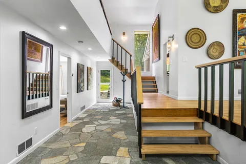 a view of entryway and hall with wooden floor