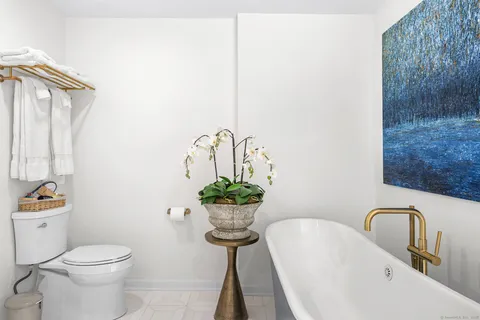a bathroom with a sink mirror and toilet