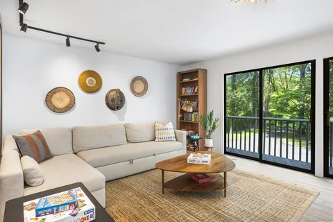 a living room with furniture and wooden floor
