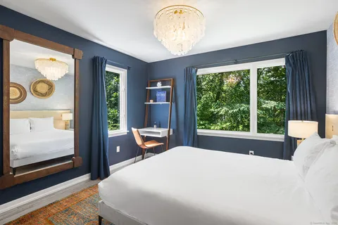 a bedroom with a bed and window with outer view