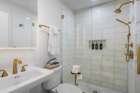 a bathroom with a sink toilet and shower