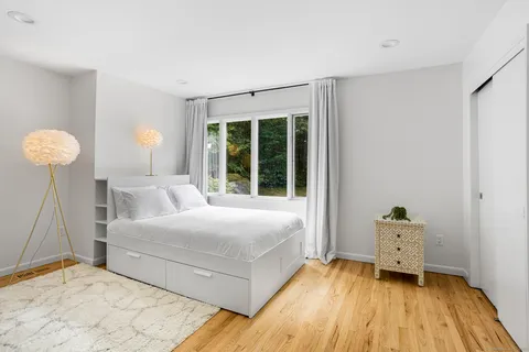 a bedroom with a bed and a window