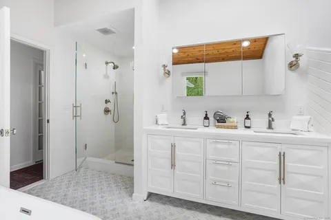 a bathroom with a sink a toilet and shower