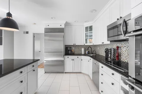 a kitchen with stainless steel appliances granite countertop a sink and cabinets