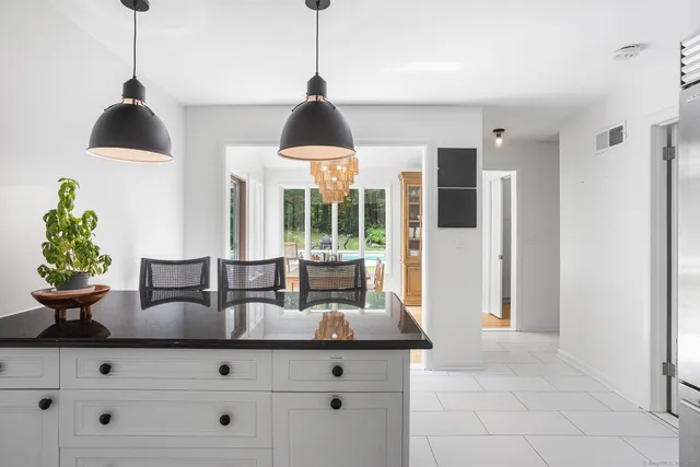 a kitchen with a potted plant on the counter and cabinets