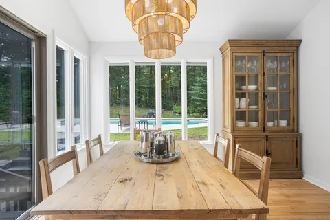 a living room filled with furniture hardwood floor and a large window