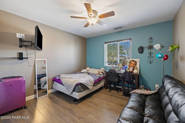 a en suite bathroom with a granite countertop sink and a mirror