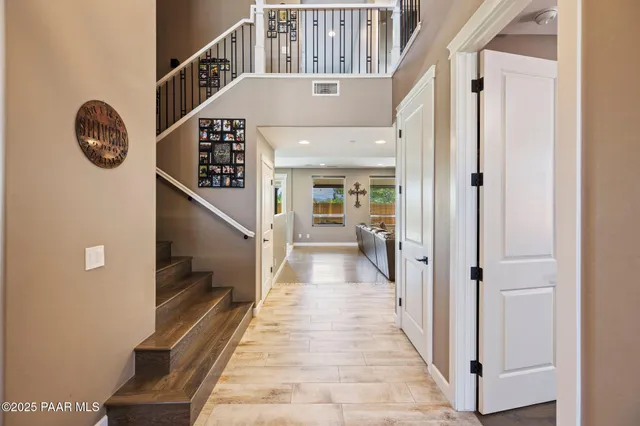 a view of a hallway with wooden floor and a hallway