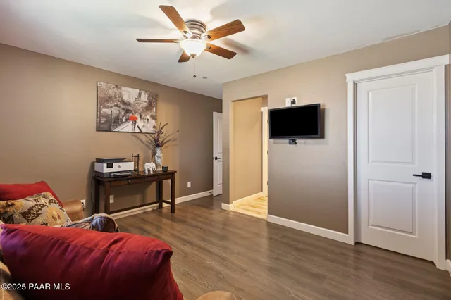 an aerial view of a house with a yard and greenery