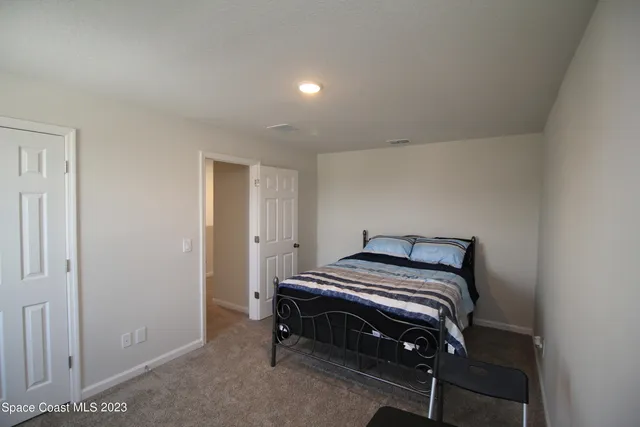 a bedroom with a bed and a table