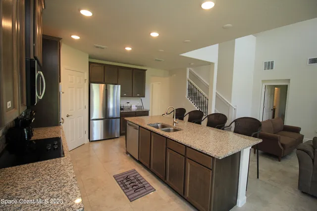 a kitchen with a sink appliances and cabinets