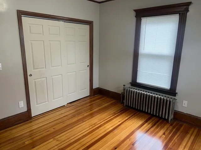 a view of a room with wooden floor