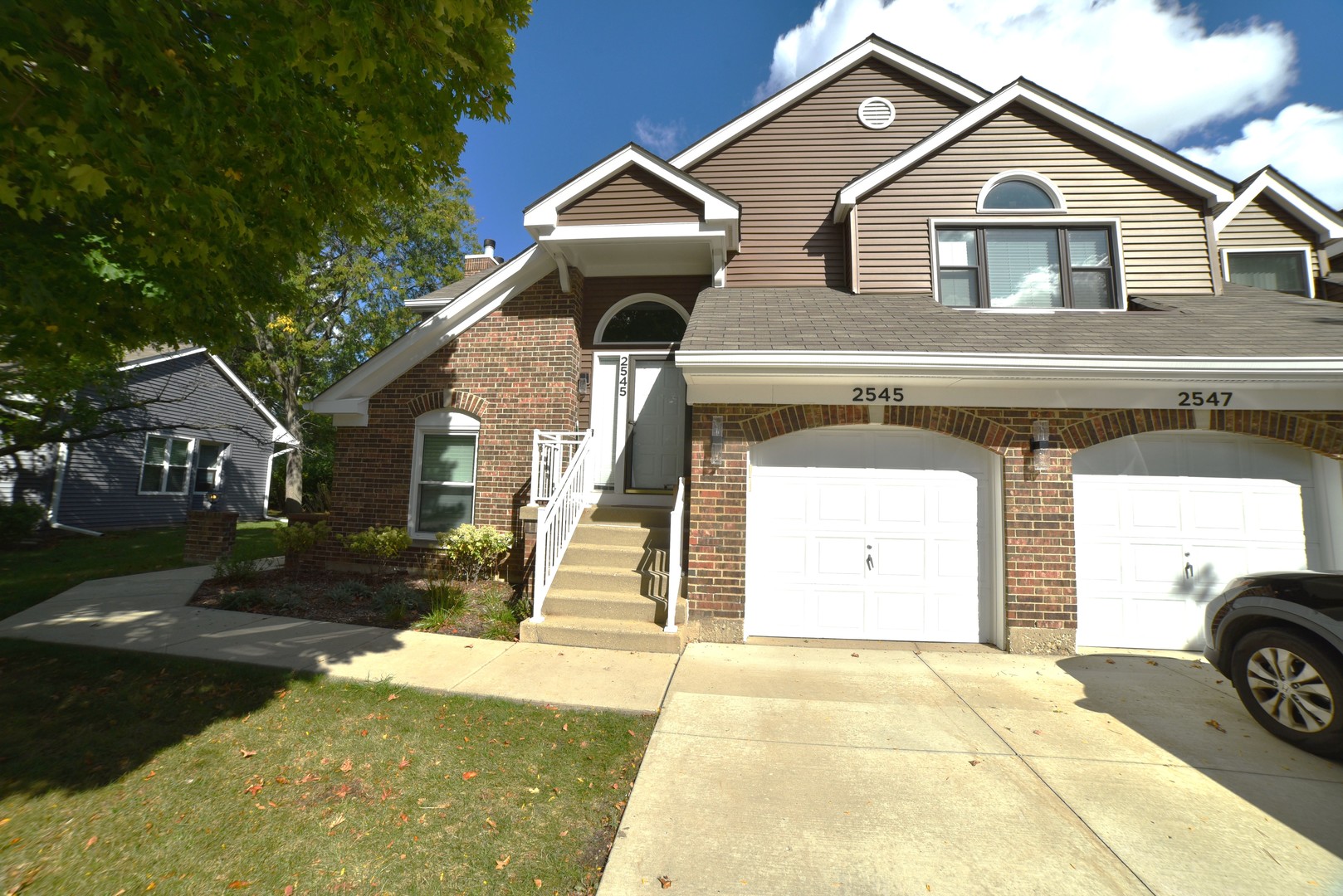 a view of a house with a yard and garage