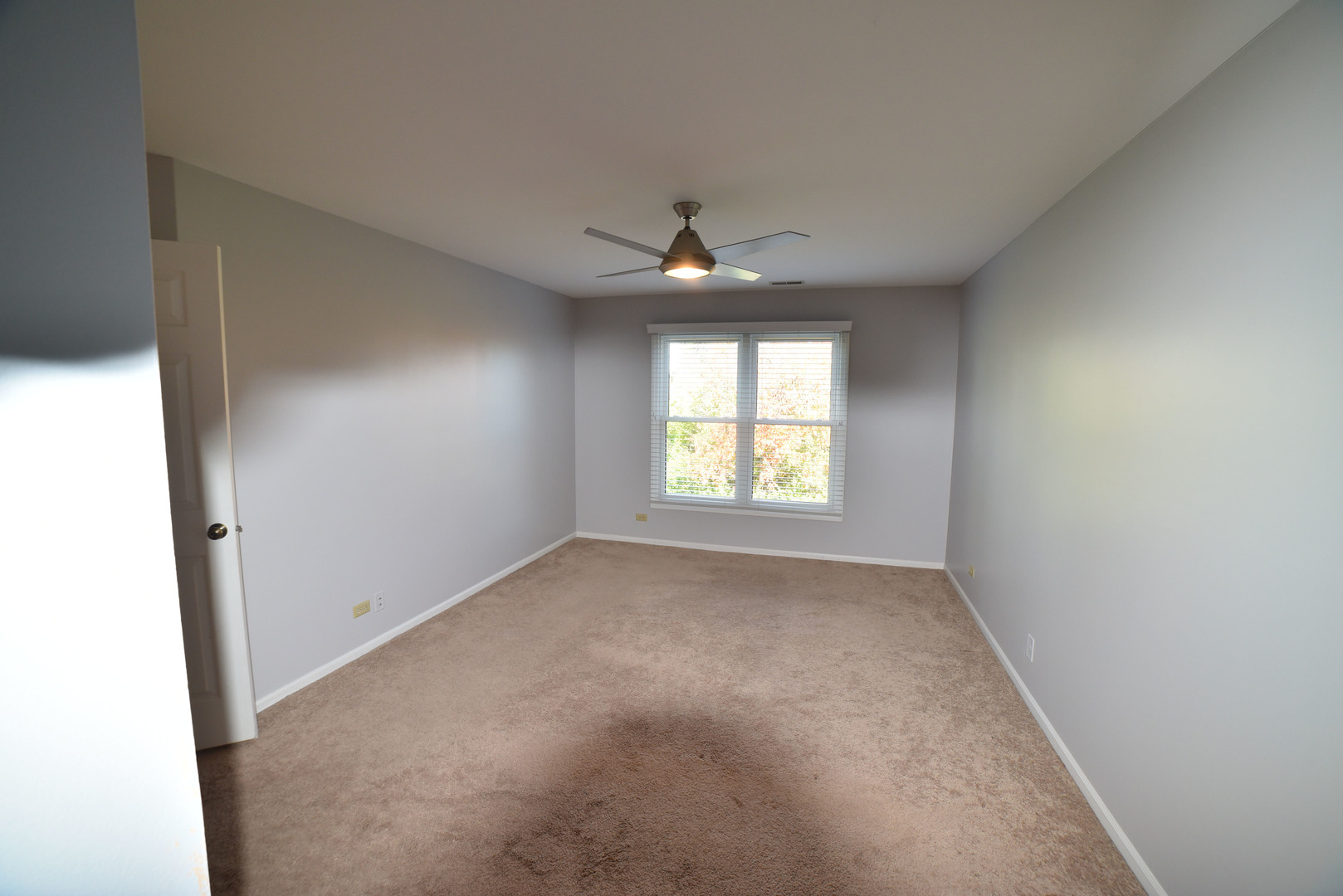 2545 Live Oak Lane Buffalo Grove, IL 60089 - Photo 12 of 21 an empty room with a ceiling fan and a window