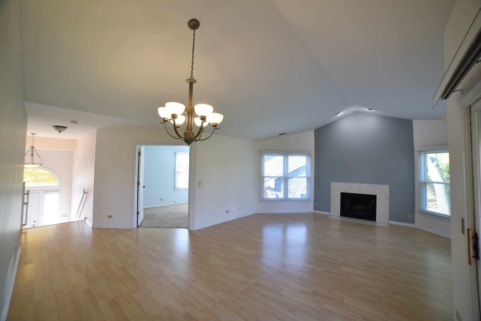 2545 Live Oak Lane Buffalo Grove, IL 60089 - Photo 5 of 21 a view of a room with chandelier fireplace and wooden floor