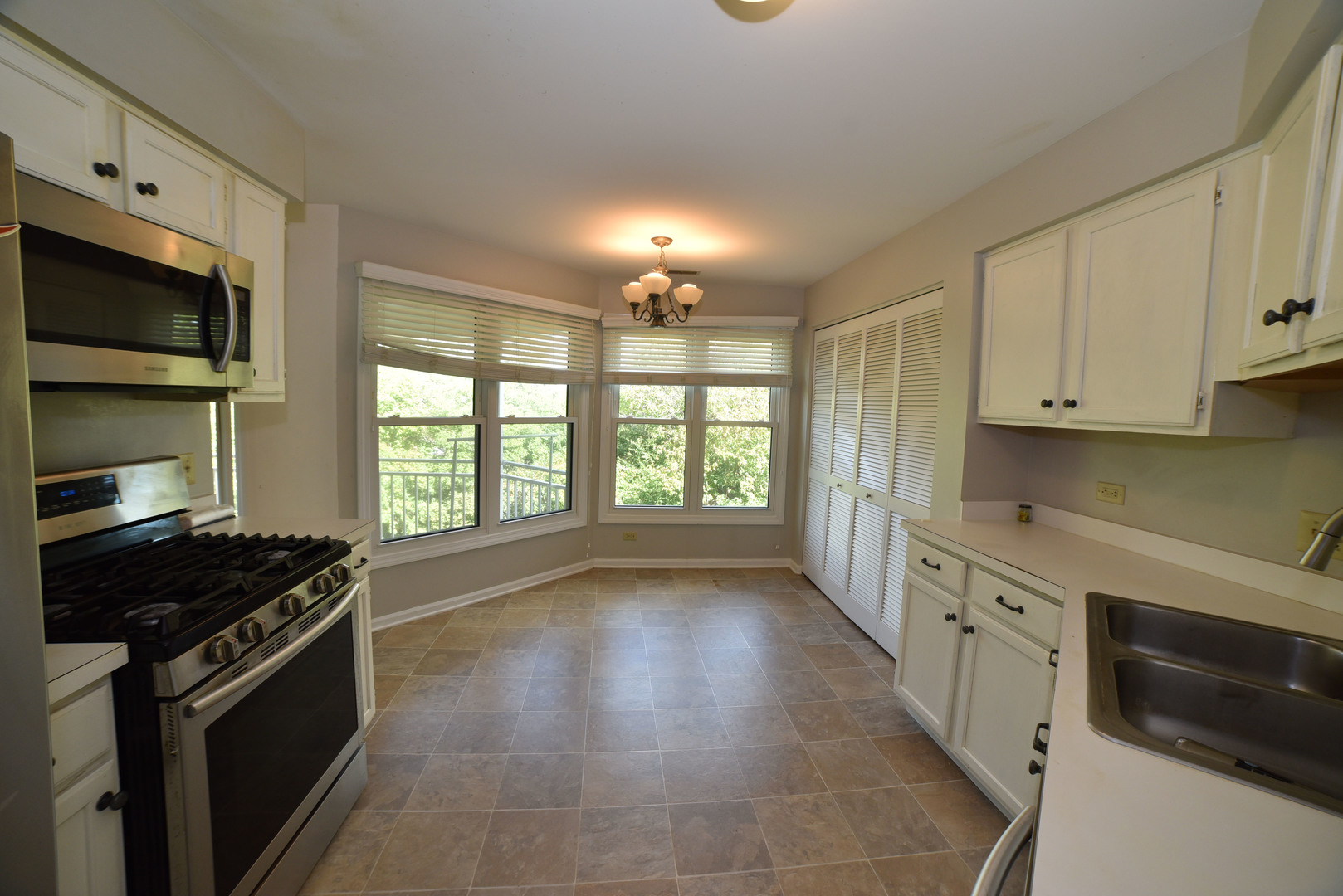 2545 Live Oak Lane Buffalo Grove, IL 60089 - Photo 7 of 21 a kitchen with stainless steel appliances a stove sink and cabinets