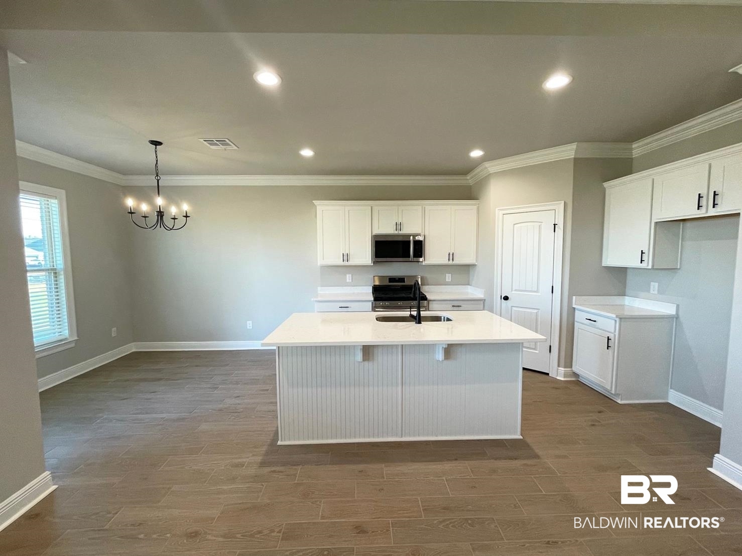 1579 Fenton Circle Foley, AL 36535 - Photo 2 of 14 Kitchen featuring stainless steel appliances, white cabinets, an island with sink, and sink