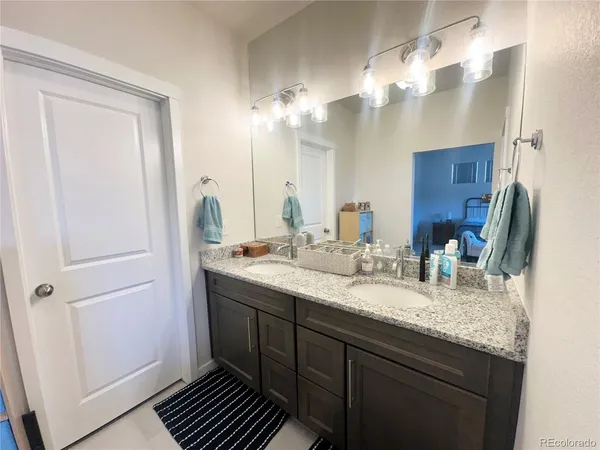 a bathroom with a double vanity sink and a mirror