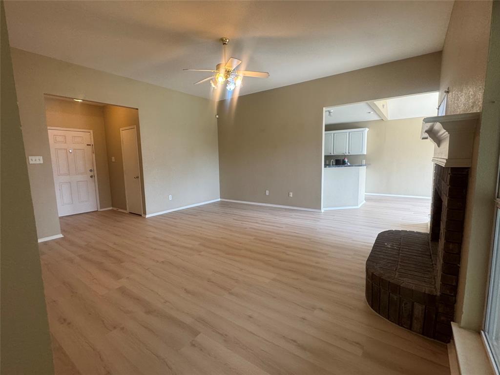 908 Cedar Ridge Lane Burleson, TX 76028 - Photo 3 of 24 a view of a livingroom with wooden floor and kitchen space