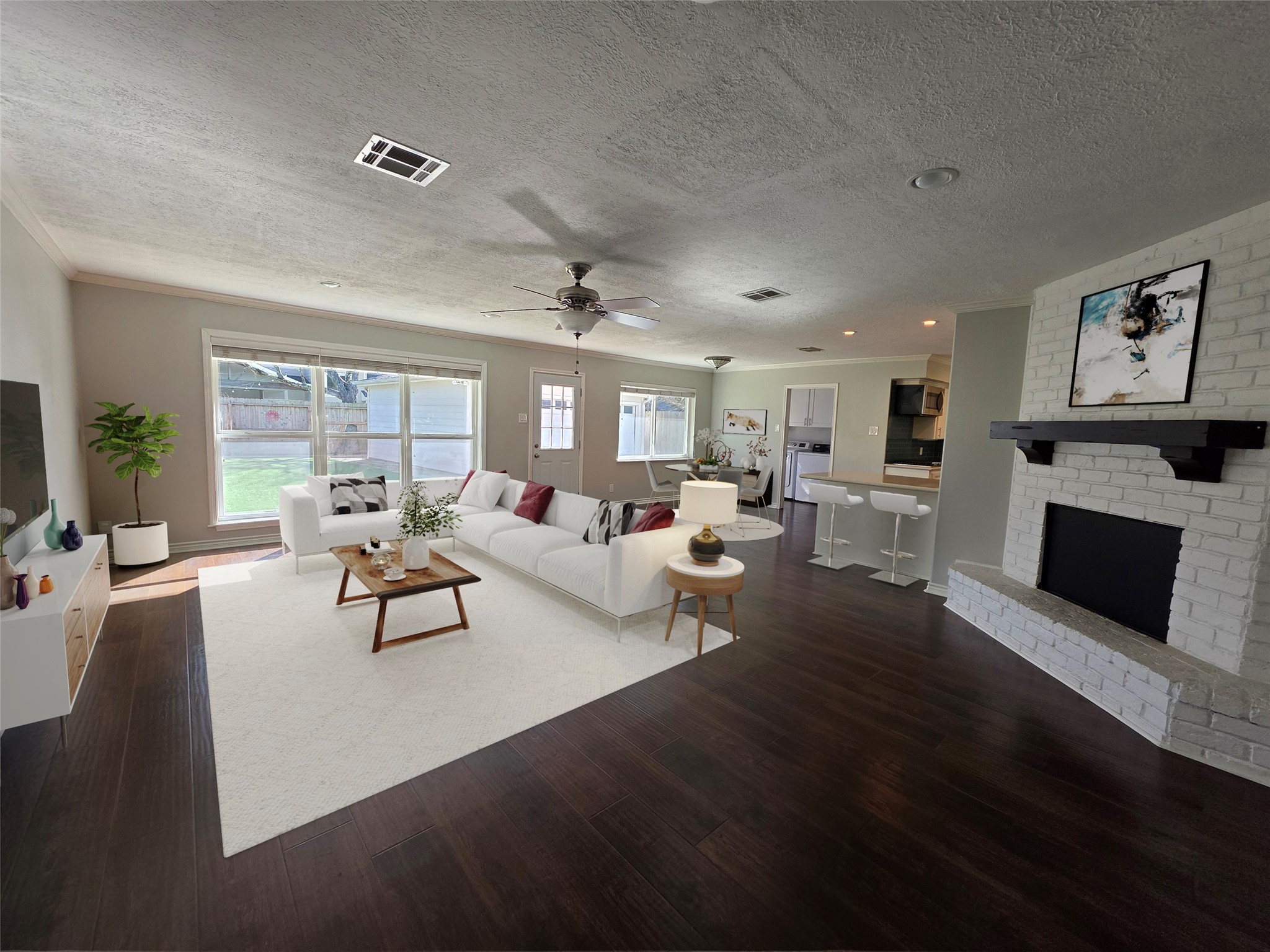 Beautiful light filled living room with a cozy chimney. Virtually staged