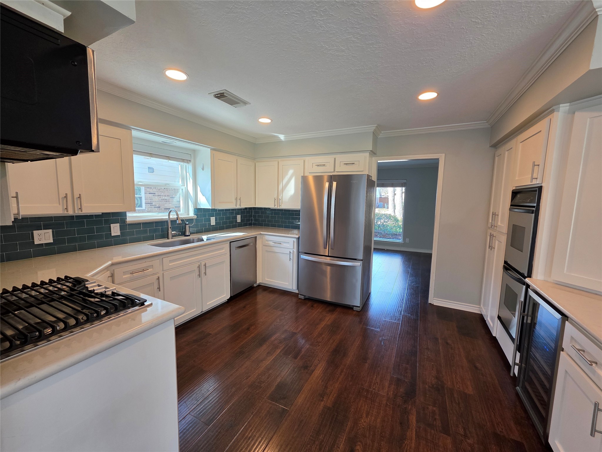 11219 Valley Spring Drive Houston, TX 77043 - Photo 4 of 31 A chef's dream! Gas stove top with dual ovens and a wine fridge.