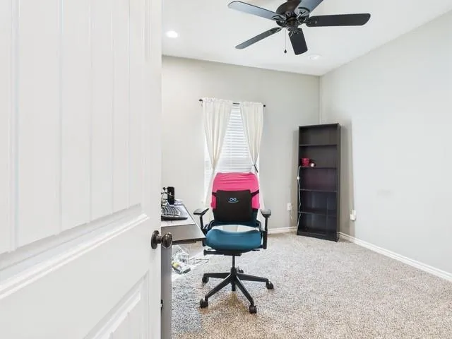 a bathroom with a granite countertop sink and a toilet