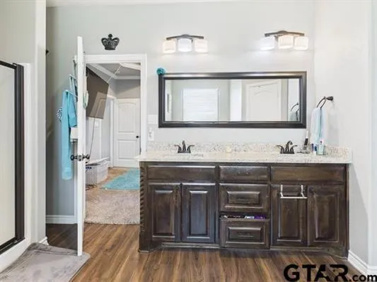 a bathroom with a tub sink and mirror