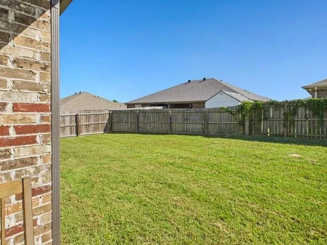 a utility room with dryer and baby crib