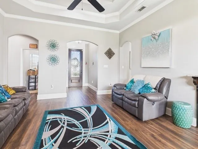 a living room with furniture and wooden floor