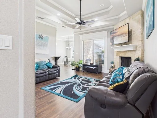 a living room with furniture fireplace and a chandelier