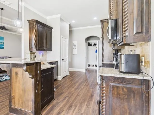 a kitchen with stainless steel appliances granite countertop a sink stove and refrigerator
