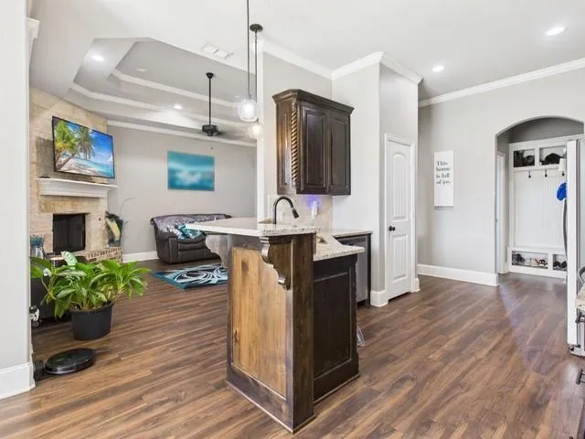 a view of backyard with potted plants and wooden fence