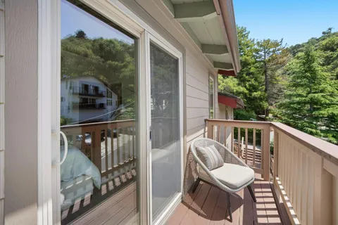 a view of a balcony with furniture